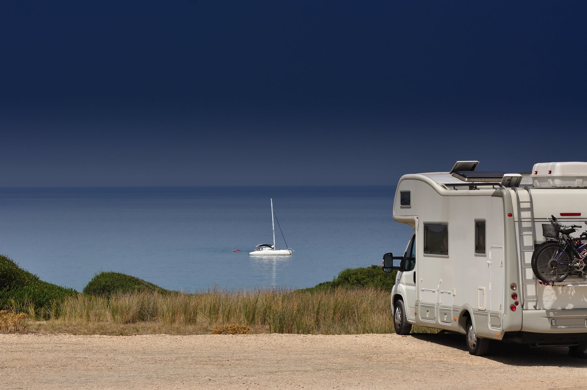 A camper van parked by the beach